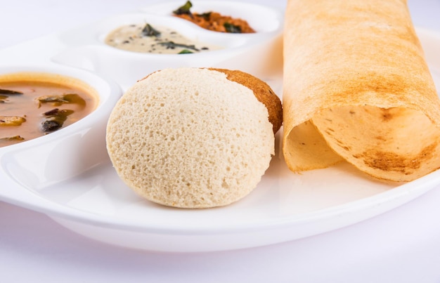 Group of south indian food dosa, idli or idly, vada, sambar coconut chutney and hot tea, south indian variety platter