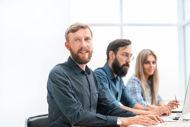 Group of specialists in the headset working on computers