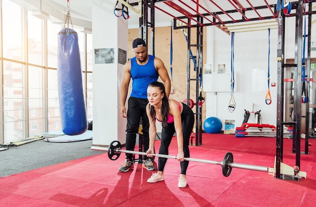 Group of sportive people in a gym training Multiracial group of athletes stretching before starting a workout session