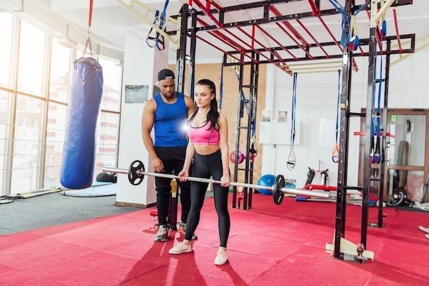 Group of sportive people in a gym training Multiracial group of athletes stretching before starting a workout session