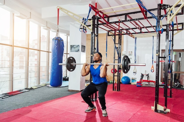 Group of sportive people in a gym training Multiracial group of athletes stretching before starting a workout session