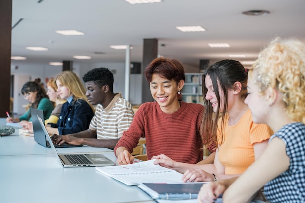 Group of students of different nationalities studying together
in the university library