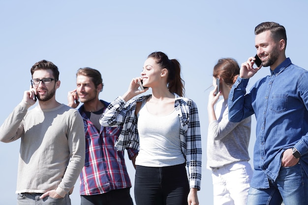 Group of students talking on their smartphones