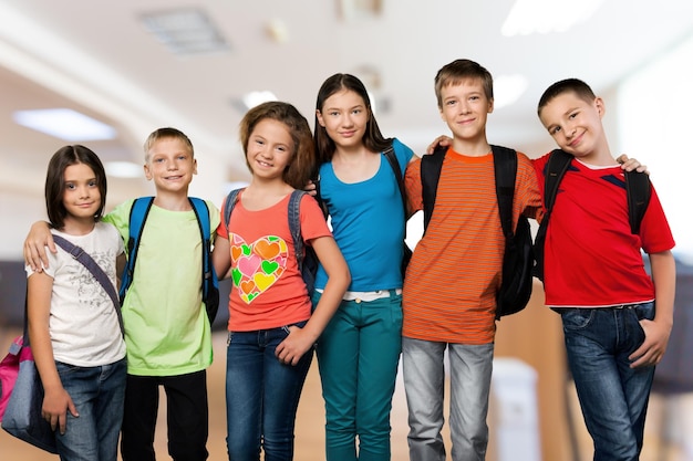 group of students with books smiling at camera