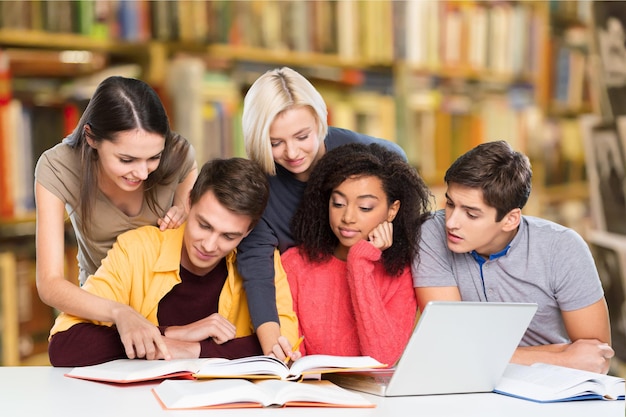 Photo group of students with computer at lesson in classroom