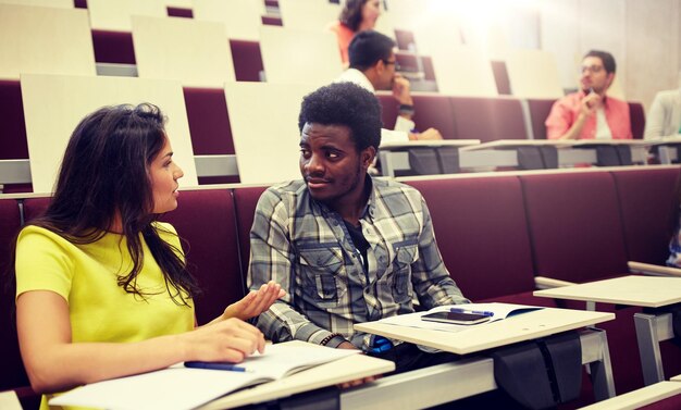 Photo group of students with notebooks at lecture hall