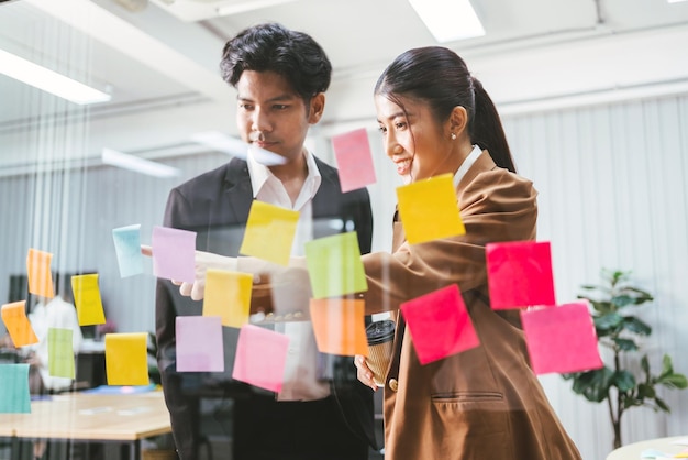 Group of successful Asian businessmen teamwork Brainstorm meeting with sticky paper notes