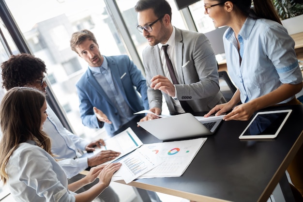 Group of successful happy business people at work in office