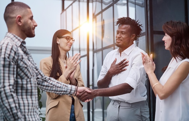 Group of successful young people standing in a conference room in the office