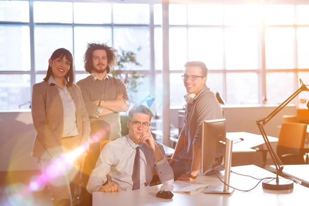 Group of successfull business group meeting in the at work with sun flare