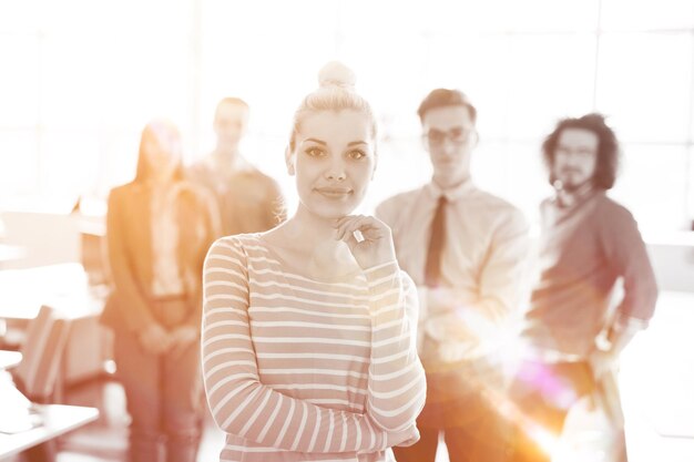 Group of successfull business group meeting in the at work with sun flare