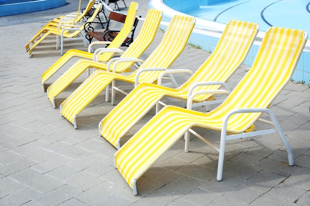 Group of sunbeds near swimming pool