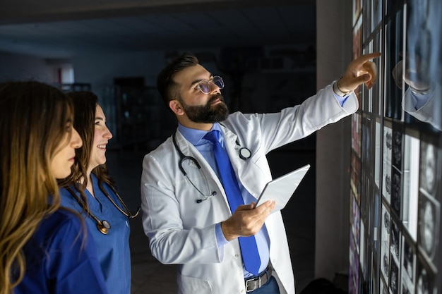 A group of surgeon interns is studying fetal development at different stages of pregnancy health education concept medical students in the classroom with images of ultrasound