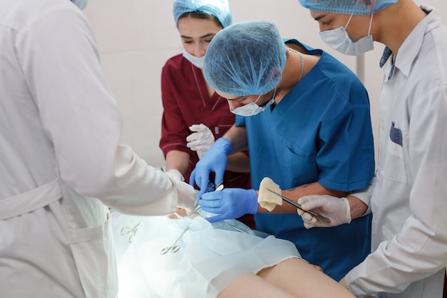 A group of surgeons doing operations in a hospital.