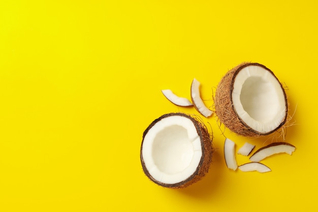 Group of tasty fresh coconut on yellow background