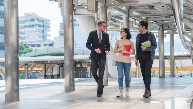 Group of teacher and students teen walk in rush time at outdoor.