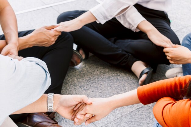 Photo group of team work people holding hands together
