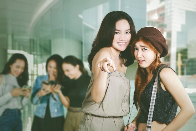 Group of teenage girl bullying somebody