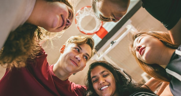 Group of teenager friends on a basketball court teamwork and togetherness concept