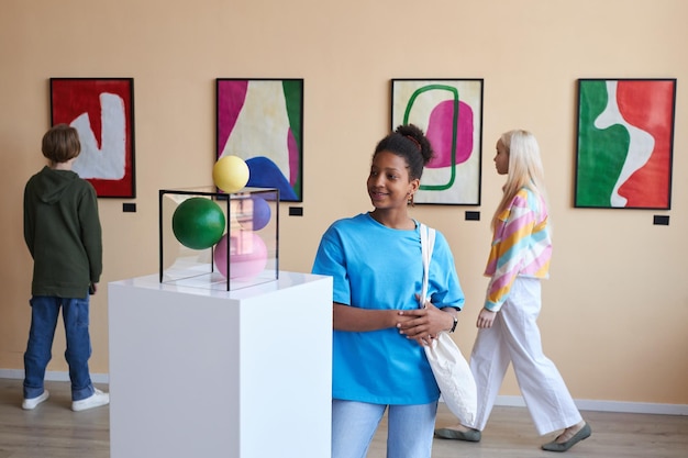 Group of teens looking at abstract art in museum