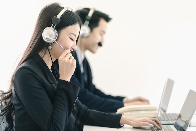 Photo group of telemarketing customer service staff team in call center 