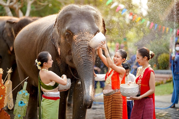 Group of Thai women ware Thai traditional dress play to splashing water on the Thai New Years Day