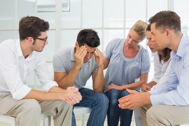 Group therapy in session sitting in a circle