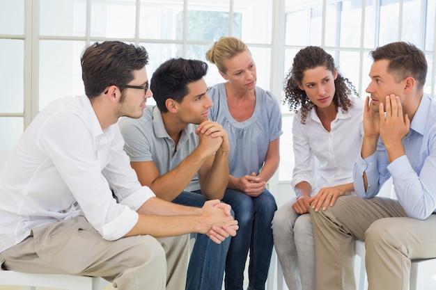 Group therapy in session sitting in a circle