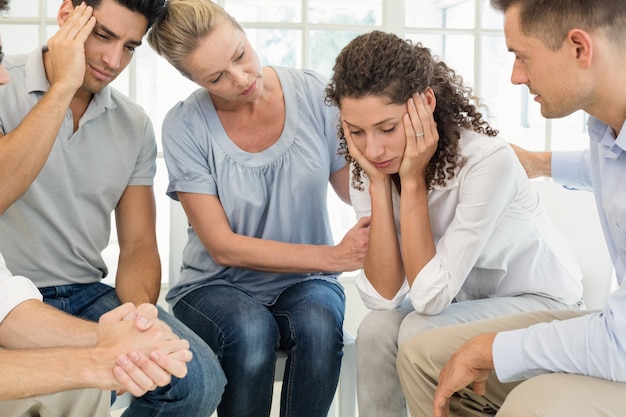 Group therapy in session sitting in a circle