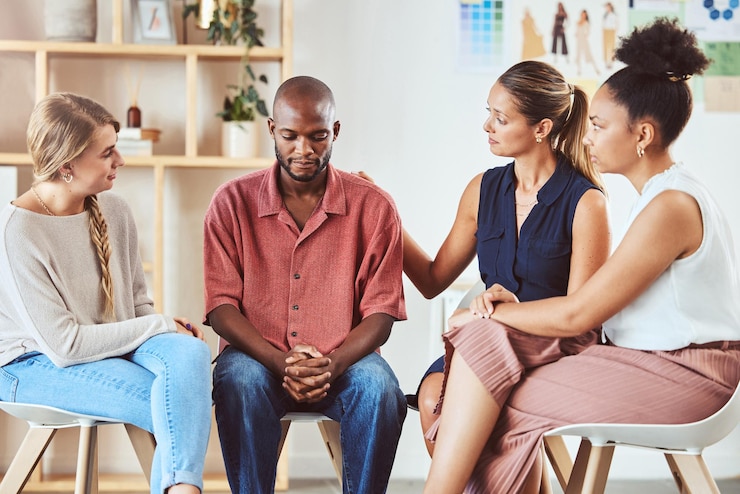 Photo group therapy support or mental health community in comfort of sad black man with anxiety depression or stress diversity friends women or people in counseling in psychology trust meeting for help