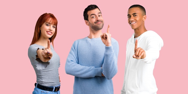 Group of three friends counting number one sign