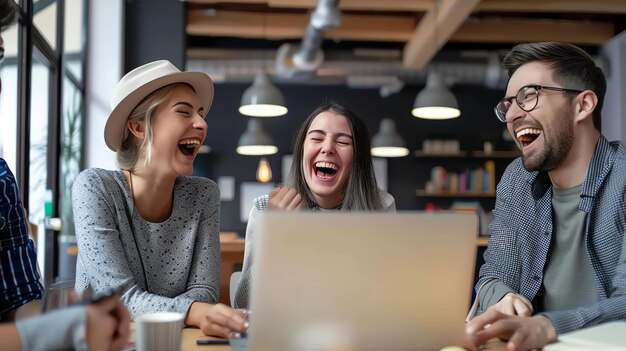 Group of three young friends laughing and having fun while sitting at a table in a cafe