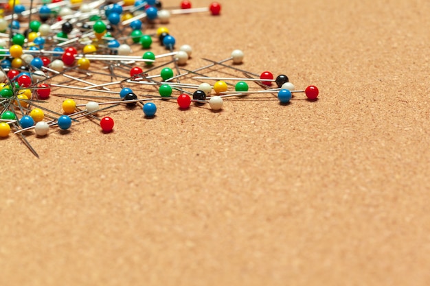 Group of thumbtacks on corkboard