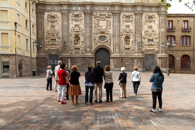 A group of tourists in front of the Church of San Cayetano and Chapel of Santa Isabel in Zaragoza