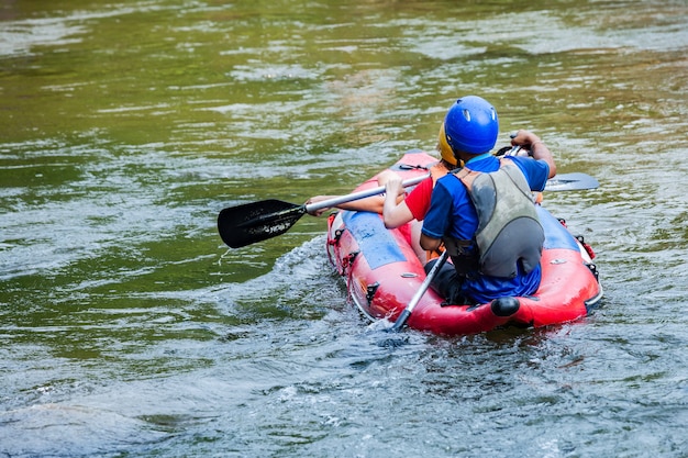 A group of tourists having fun on white water rafting in Mae Taeng river. Thailand.