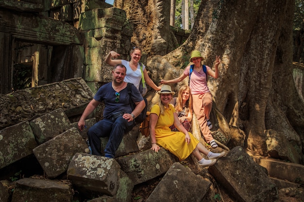 Group of tourists in the ruins of the temple  Ta Prohm.