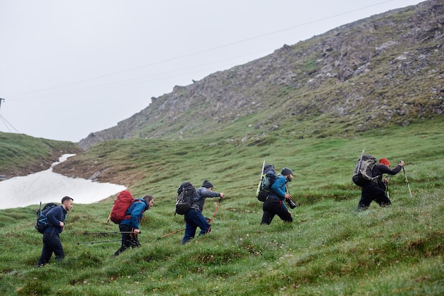 Group of travelers climbing the mountain