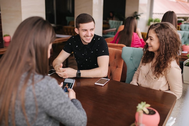group of tree friends on terrace yound people meeting in cafe friends sitting in cafe together meeting