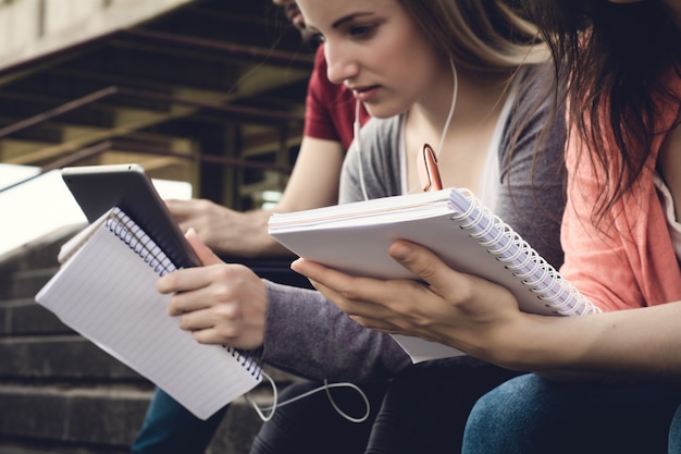 Group of  University students studying together outdoors