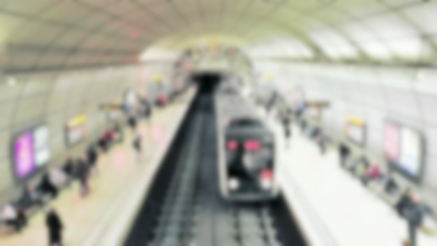 Group of unrecognizable anonymous people in bokeh in the subway Defocused image