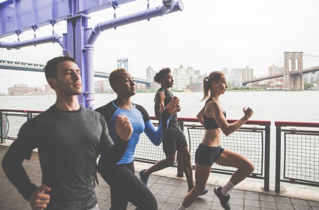 Photo group of urban runners running on the street in new york city, conceptual series about sport and fitness