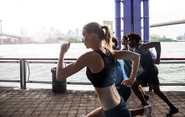 Group of urban runners running on the street in New york city, conceptual series about sport and fitness