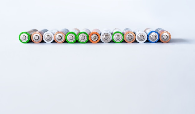 A group of used disposable batteries of different colors.