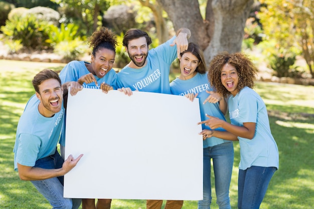 Group of volunteer holding a blank sheet and pointing to it