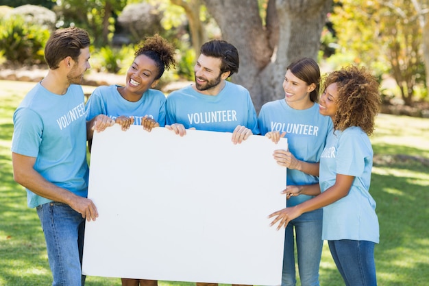 Photo group of volunteer holding blank sheet