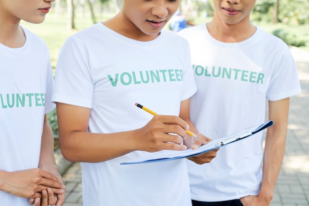 Group of volunteer with clipboard outdoors