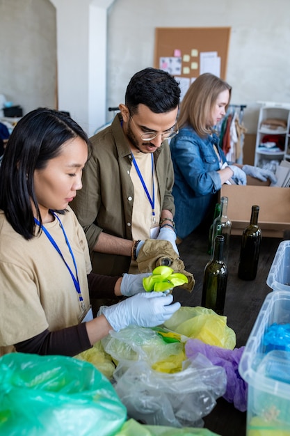 A group of volunteers checking donation stuff by table