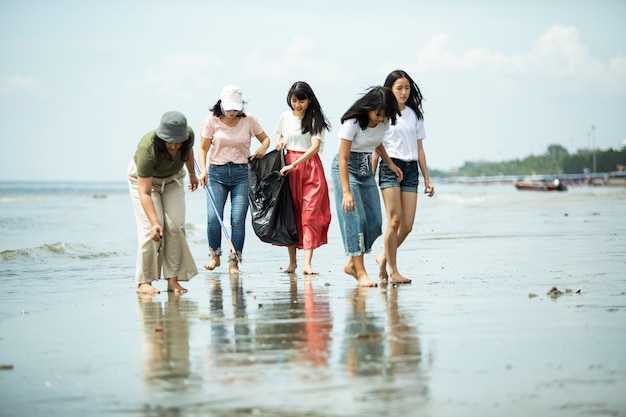 Group of volunteers keeping the beach clean