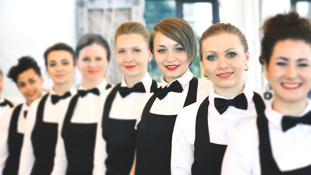 Group of waiters at a prestigious restaurant standing in the col