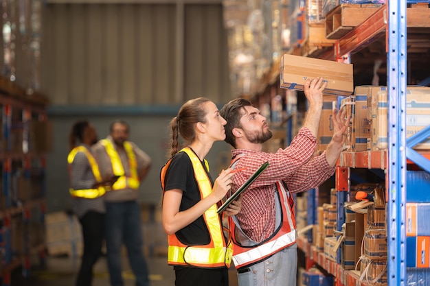 A group of warehouse employees Inspecting products on warehouse shelves